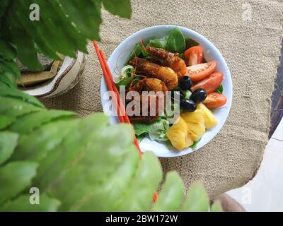 Fried Shrimp With Vegetables chunks of pineapple in a bowl Stock Photo