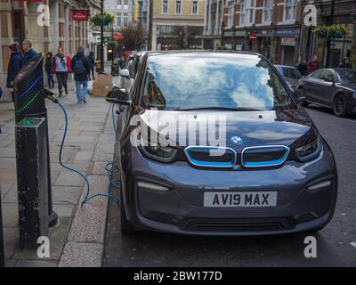 BMW i3 electric car being charged at the roadside in Covent Garden. London Stock Photo
