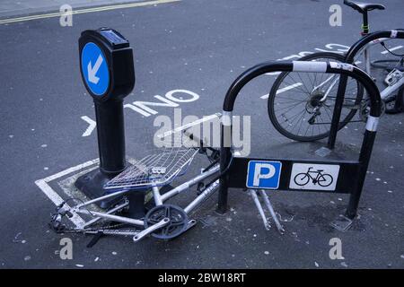 Bike on the side of street with the wheels stolen from it. London Stock Photo