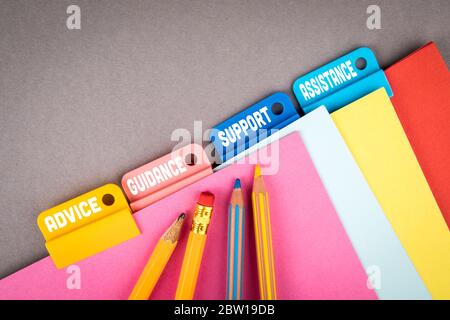 ADVICE, GUIDANCE, SUPPORT and ASSISTANCE concept. Folder Register of Card Index. Colored pencils and sheets of paper Stock Photo