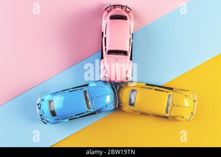 Izhevsk, Russia, February 15, 2020. Toy cars in accident on a pastel colorful background. Three car accident scene, Car crash insurance. Racing cars o Stock Photo