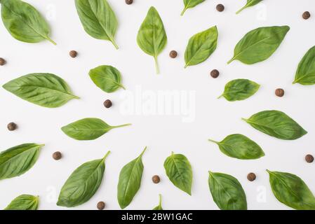 Top above overhead view photo of basil leaves and peppercorns isolated on white background Stock Photo
