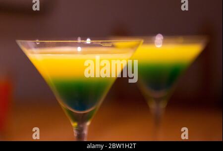 Blue and yellow cocktails in martini glasses Stock Photo