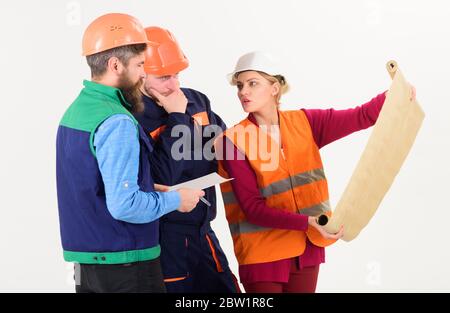 Team of builder, engineer, architect work on project. Plan of build concept. Men and woman in helmets, architects on busy faces looks at drawing, plan, blueprint, project, white background. Stock Photo