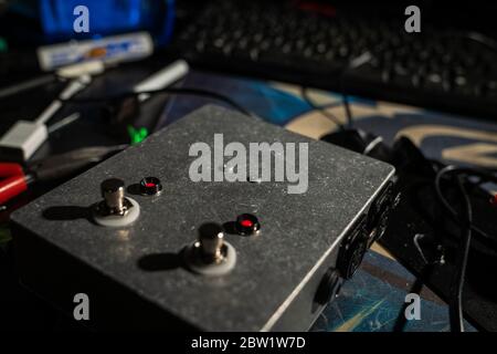 A custom made rugged pedal for switching of audio, made of steel. With stomp box switches, XLR connectors and red LED lights. Stock Photo