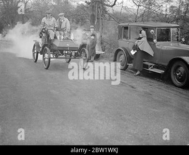 'Full steam ahead' in old crocks hill climb. Ancient cars, none later than 1904, competed in the veteran car clubs rally to Godstone, Surrey, and hill climb at till Tilburstow nearby. Photo shows, Maj G W G Allen's 1901 Foster (steam) wagon emitting clouds of steam as it chuges up the hill 16 April 1937 Stock Photo