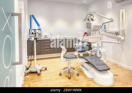 Fully equipped modern dental clinic box, with white walls and wooden  flooring Stock Photo - Alamy