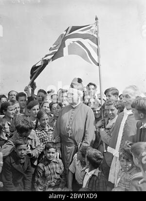 Basque children in religious procession has Hampshire camp. Led by the 15 priests who accompanied them from Spain, the refugee Basque children marched in procession around the North Storeham camp near Southampton, to celebrate the Feast of Corpus Christi. Banners and other equipment was sent from the neighbourhood. Photo shows, the Roman Catholic Bishop of Portsmouth was some of the children at the camp. The Bishop is the Rev William T Cotter. 27 May 1937 Stock Photo