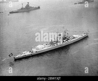 German 'pocket' battleship 'dressed' at Spithead for naval review. A view from the air of the German 'pocket' battleship 'Admiral Graf Spee' gaily 'dressed' at split head for the great Coronation naval review by the King and Queen for stop. 17 foreign warships are attending the review 20 May 1937 Stock Photo