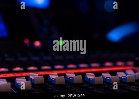 Close up of faders on an audio mixing console in a concert venue Stock Photo