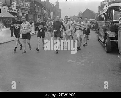 Police compete in Barking - Southend Walk. Police athletes started from Barking Police Station on their annual Barking - Southend. Photo shows: competitors on the road. 29 April 1937 Stock Photo