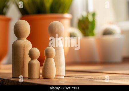 Small wooden figures of family members. Family relationship symbol Stock Photo