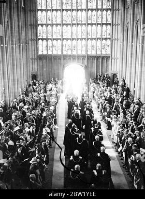 First Garter service for 23 years takes place with colourful ceremonial at Windsor. The King, as Sovereign of the order, with the Queen and Queen Mary walked into the colourful procession through Windsor Castle, when the first service of the Most Noble Order of the Garter to be over 23 years took place in St George's Chapel. The most exclusive order of chivalry in the world. The order was founded by Edward III in 1348. It houses motto ' Honi soit qui mal y pense '(shame on him who thinks elevate). This remark was attributed to Edward III when he picked up Garter dropped by the Countess of Sali Stock Photo