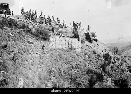 British forces are now consolidating their position on the North West Frontier of India [now in Pakistan], where they had been waging a big scale campaign against rebellious tribesmen stired up by the elusive Fakir of Ipi. British Indian troops building a fortress was an imminence near the Iblanke Spur. 19 July 1937 Stock Photo