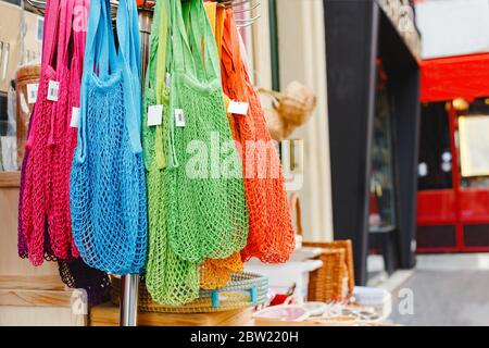 String bags. Store with many different colors string bags, basket. No plastic, zero waste concept store. Recyclable reuse shopping bags in eco Stock Photo