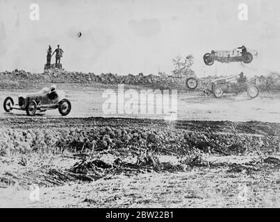 This amazing picture, made the split second after the two racing cars had crashed shows the machine driven by Curly Aschelman careering through the air over the head of Carl van Acker at the Mew Hammond Speedway, Indiana. The front wheel of Van Acker's racer can be seen rolling into the wall surrounding the track. Both drivers were seriously injured. 22 September 1937 Stock Photo