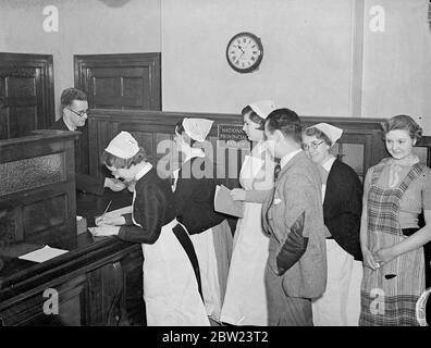 Guys is first British hospital to have its own bank. Guy's Hospital, London, is the first hospital in the country to have its own bank for the use of its staff. The bank has been opened in a part of the main building. It is a sub branch of the Southwark branch of one of the 'Big Five' banks, and hospital staff will be paid there, about 500 receiving their wages weekly, and 1000 monthly. Money may be paid into the bank as well as withdrawn. Photo shows, the administrator staff of Guy's Hospital using a hospital bank. 12 February 1938 Stock Photo