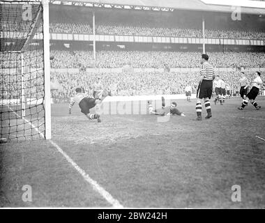 Tottenham Hotspur met Fulham in an all London second division match at White Hart Lane. Photo Shows: Turner, the Fulham goalkeeper on the ground, beaten but Hilies, the Fulham centre half dashes in and saves on the goal line what appears to be a certain goal. 15 October 1938 Stock Photo
