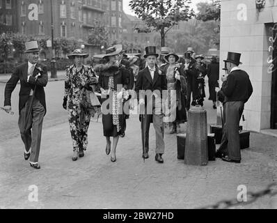 Harrow are attempting to score the first cricket win since 1908 over their great rivals, Eton, in the annual two-day match which has started at Lord's. Girls in summary frocks and top-hatted male escorts arriving at Lord's. 9 July 1937 Stock Photo