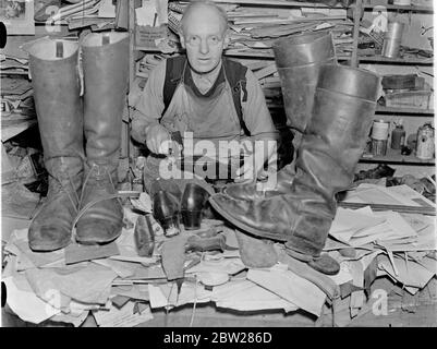 Cobblers family has shod villagers for 200 years. He made shoes for the Pope. For nearly 200 years a member of the Brett family has been village cobbler at Wonersh, near Guildford in Surrey. Nowadays, Mr William Brett carries on the tradition, and he has had a special distinction. He has made a special pair of shoes for the Pope. The shoes were inlaid with gold braid and the hill covered in gold. The gold cross was also inlaid in the toecap. Photo shows, Mr William Brett at work in his cobblers shop at Wonersh. 15 January 1938 Stock Photo