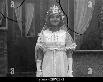 14-year-old London girl, as May Queen of England in 1938. Flossie Boggin, aged 14, of Grove Park, has been chosen to be the May Queen of England for 1938 by Mr Joseph Deeley, organiser of the Merrie England Society. She will be crowned on Hayes Common, Kent, on May Day, when Queens from all over England will attend her. Last year. Flossie was Princess of the Fairies at the May Day celebrations, and the year before was May Queen of Grove Park. One of her attendance as May Queen of England will be has seven-year-old brother, Malcolm Boggin. Flossie is a scholarship girl at a South East London, t Stock Photo