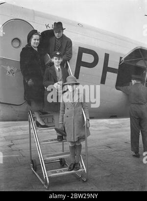 School family party, leaves by a to spend Christmas with father in Karachi. A family party of school boys and girls, left, Croydon aerodrome by the KLM liner for Karachi, where they are to spend their Christmas holiday. Leader of the parties, 20-year-old Mr H H Monroe of Rugby, who with his sisters, is joining their father, a justice of the peace in Karachi. Photo shows, Mr H H Monroe with his sisters, 17-year-old Miss A Monroe (Somerfield College, Oxford), Miss N Monroe (10) and a friend, J Coldstream, aged 11, who is travelling with them, waving on departure from Croydon. 6 December 1937 Stock Photo