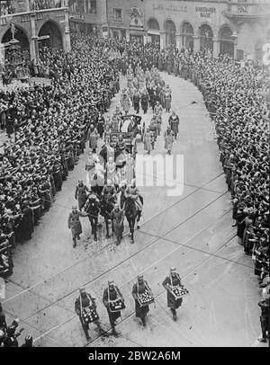 Military funeral of General Ludendorff in Munich. The military funeral procession of General Erich Ludendorff, famous German army commander, past three Munich from the Victory Gate to the Feldherrnhalle, where the funeral oration was delivered by Field Marshal von Bromberg, the War Minister. The coffin was then taken on the gun carriage to the centre of the city, where it was transferred to a motor hearse and driven to Tutzing, the general's home village for burial. Chancellor Hitler and other Government members walked in the procession. Photo shows, the cortege passing through the crowd lined Stock Photo