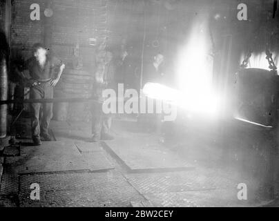 Where Britain forges victory. This pictures were taken in a Royal Ordinance factory of the Ministry of Supply where, thousands of workers are producing arms and ammunition which will help to ensure the victory of Britain and her Allies. Photo shows: Sparks fly from a converter (steelmaking furnace). 13 November 1939 Stock Photo