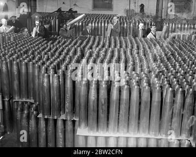Where Britain forges victory. This pictures were taken in a Royal Ordinance factory of the Ministry of Supply where, thousands of workers are producing arms and ammunition which will help to ensure the victory of Britain and her Allies. Photo shows: inspecting a great mass of anti-aircraft cartridge cases. 13 November 1939 Stock Photo