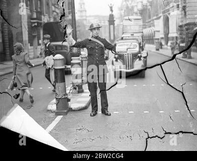 Police in the City of London are now on duty in steel helmets. A policeman directing traffic. 2 September 1939 Stock Photo