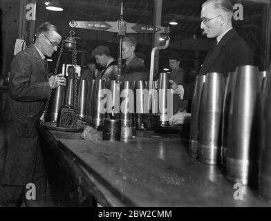 Where Britain forges victory. This pictures were taken in a Royal Ordinance factory of the Ministry of Supply where, thousands of workers are producing arms and ammunition which will help to ensure the victory of Britain and her Allies. Photo shows weighing shells. 13 November 1939 Stock Photo