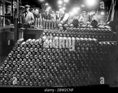 Where Britain forges victory. This pictures were taken in a Royal Ordinance factory of the Ministry of Supply where, thousands of workers are producing arms and ammunition which will help to ensure the victory of Britain and her Allies. Photo shows a wall of stacked shells in the background shells are being weighed. 13 November 1939 Stock Photo