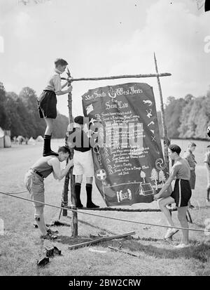 The County of Hertfordshire Boy Scout Rally is taking place in Hatfield Park over the weekend. Photo shows: Scouts with the 33rd South West Herts erecting the Scouts law. 1 June 1939 Stock Photo