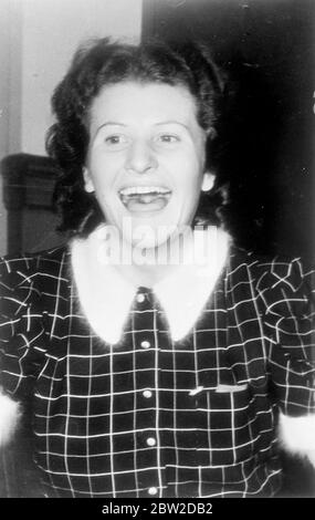 A carefree laugh by Johanne Hofmann, former hairdresser on the German liner Europa's, as she entered the federal court in New York to stand trial, with three men, on charges of implication in a great spy ring working in the United States on behalf of Germany. Fraulein Hofmann, 26-year-old redhead, is alleged to have carried stolen US military secrets across the Atlantic. If found guilty she can receive up to 20 years imprisonment. 24 October 1938 Stock Photo