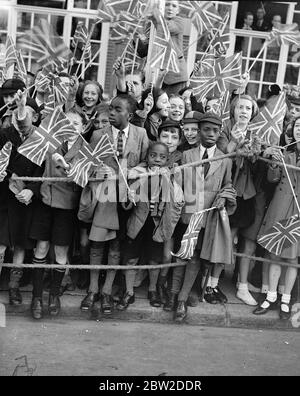 1200 children, from more than 100 schools, were among the great crowds which cheered Queen Mary when she opened the new Â£90,000 extension to Lambeth Town Hall, Brixton. Photo shows: black children waving flags as Queen Mary arrived. 14 October 1938 Stock Photo