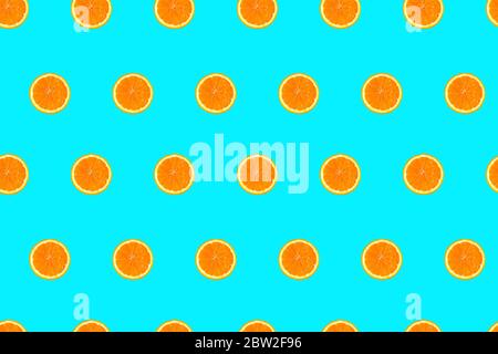 Orange halves on bright light blue background seamless pattern. Stock Photo