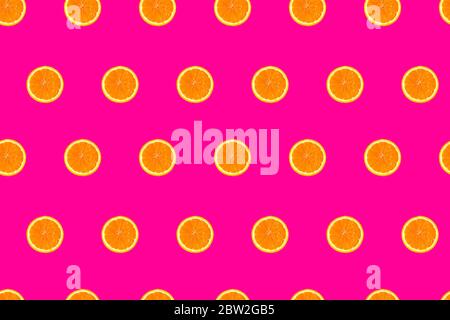sliced oranges on bright pink background seamless pattern. Stock Photo