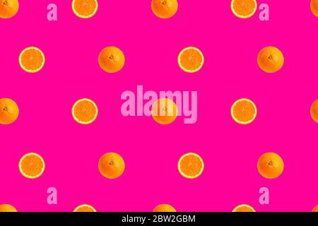orange halves on bright pink background seamless pattern. Stock Photo