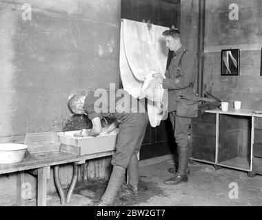 The Royal Mews at Buckingham Palace where soldiers who arrive in the night may have a bed and breakfast. Soldiers at the ablutions. 1914 - 1918 Stock Photo