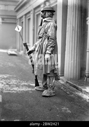Air Raid precautions demonstrated by 1st Bn.Genadiers Guards and 1st Bn. Coldstream Guards at Wellington Barracks. Sentry in gas mask. 10 February 1938 Stock Photo