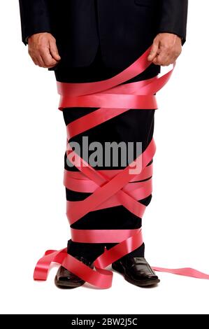 A businessman tied up in red tape Stock Photo