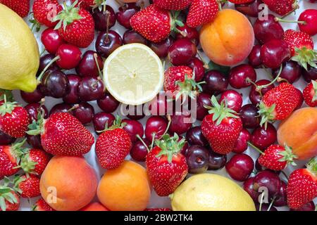 Directly above shot of various fruit - strawberries, cherries, apricot, lemon Stock Photo