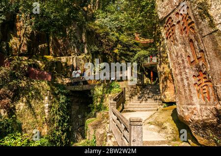 Old rock carvings near a spring at Yongquan Temple on Gu Mountain in the hills above Fuzhou city. Stock Photo