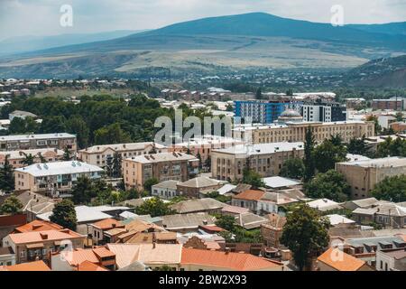 Looking out over the city of Gori, in eastern Georgia. The long building with the dome is the Gori City Hall Stock Photo