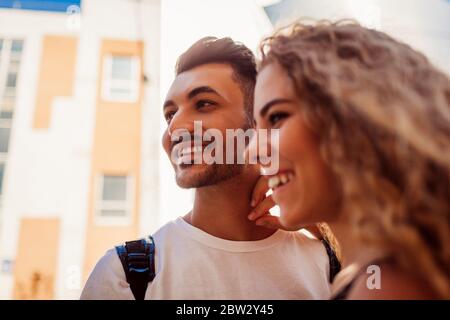 Mixed race couple in love laughing outdoors. Happy arab man and white woman walking in city on date. Diversity Stock Photo