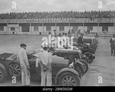 A close race at Brooklands . Crowds thronged the Brookland track for the great Easter Monday opening meeting when Sir Malcolm CAmpbell took out his Bluebird on the track . The line up at the start of the Norfolk Senior Mountain Handicap race . 28 March 1932 Stock Photo