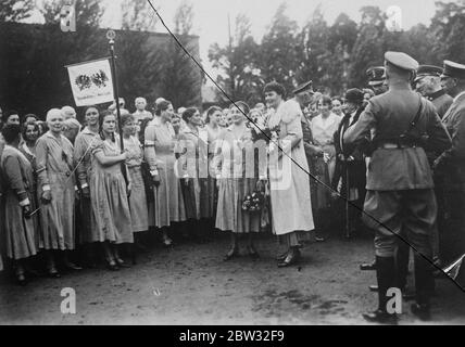 German Crown Princess presides at meeting of women Nationalists in Potsdam . Following a review of the Steel Helmets in Potsdam by the former German Crown Prince , the former Crown Princess Cecilie presided at a meeting of women Nationalists in Potsdam , at which the Crown Prince was also present . Every effort is being made by Nationalists to keep the former members of the Imperial Family in the public eye . The Crown Princess addressing the women nationalists at a meeting in Potsdam . The ex Crown Prince is standing on right . 20 September 1932 Stock Photo
