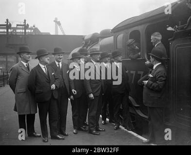 Station masters meeting in London to discuss their problems . Station masters from the London and North Eastern Railway stations all over England met at Liverpool Street station , London , for a conference to discuss their problems and establish personal contact between the stations . Among those present were station masters from Hull , Sunderland , Dundee , Manchester , Newcastle , Edinburgh , York , Glasgow , Marylebone and Kings Cross . Some of the station masters attending the conference chatting to an engine driver at Liverpool Street station , whose master Mr Hubert Calver may be seen ne Stock Photo