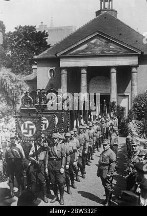 Nazi victim of Berlin riots has imposing funeral . The imposing funeral procession leaving the Friedhof Chapel in Berlin when Hellmut Koster , a Nazi victim of the Berlin Nazi - Communist riots was buried with full honours . 28 June 1932 Stock Photo