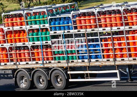 Calor Gas fuel, Patio gas, 18kg Propane, 4.5kg blue Butane, Haulage delivery trucks, lorry, transportation, truck, cargo carrier, DAF vehicle, European commercial transport, industry, M61 at Manchester, UK Stock Photo